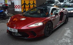 Caption: Sleek And Stylish Mclaren Gt Cruising Along The Road Wallpaper