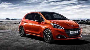 Caption: Sleek And Stylish Peugeot 208 In Action Wallpaper