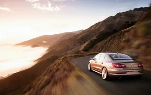 Caption: Sleek And Stylish Volkswagen Passat Cc Glistening Under The City Lights Wallpaper