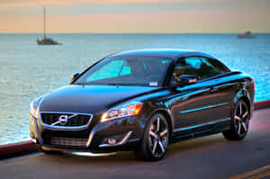 Caption: Sleek And Stylish Volvo C70 On The Road Wallpaper