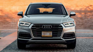 Caption: Sleek Audi Q5 In Urban Landscape Wallpaper