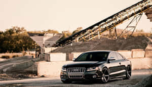 Caption: Sleek Audi S6 Sport Sedan On Urban Road Wallpaper