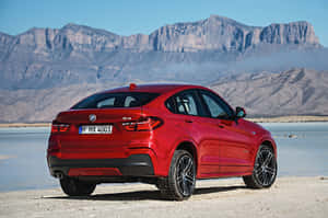 Caption: Sleek Bmw X4 In Motion On A Highway Wallpaper