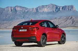 Caption: Sleek Bmw X4 In Motion On A Highway Wallpaper