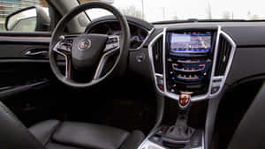 Caption: Sleek Cadillac Srx Driving On Open Road Wallpaper