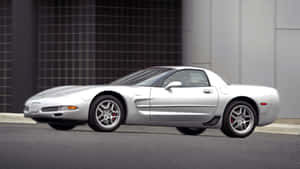 Caption: Sleek Chevrolet Corvette C5 Powering Down The Highway Wallpaper