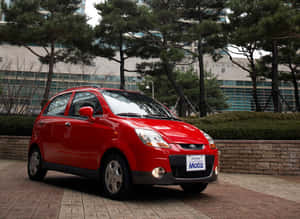 Caption: Sleek Daewoo Matiz Car In Red Wallpaper