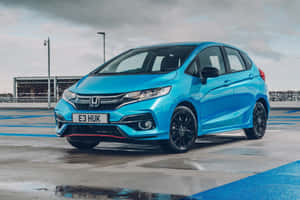 Caption: Sleek Honda Fit In Vibrant Blue Wallpaper