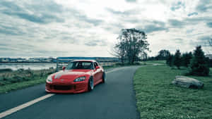 Caption: Sleek Honda S2000 In Vibrant Setting Wallpaper