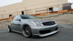 Caption: Sleek Infiniti G35 Cruising On Open Road Wallpaper