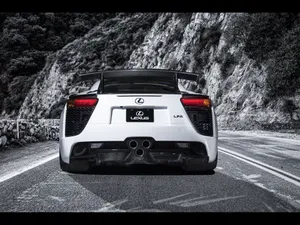 Caption: Sleek Lexus Lfa Sports Car On A Scenic Road Wallpaper