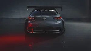 Caption: Sleek Mazda 3 Hatchback Cruising On The Highway Wallpaper