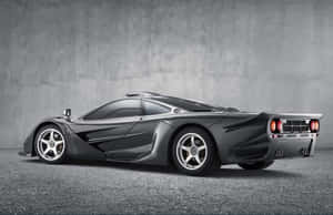 Caption: Sleek Mclaren F1 Sportscar On Track Wallpaper