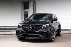 Caption: Sleek Mercedes-benz Gla-class Parked In A Breathtaking Urban Landscape Wallpaper