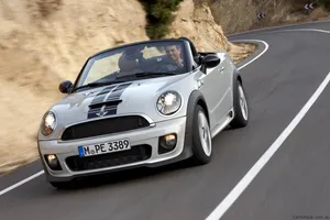 Caption: Sleek Mini Roadster Cruising Down The Highway Wallpaper
