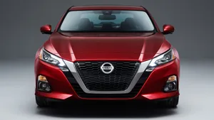 Caption: Sleek Nissan Altima Cruising On Scenic Route Wallpaper