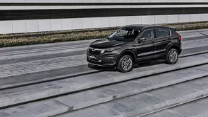 Caption: Sleek Qoros Sedan On An Open Road Wallpaper