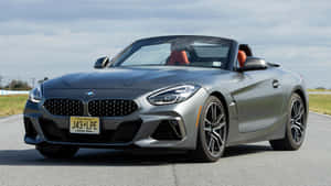 Caption: Sleek Red Bmw Z4 Roadster In Action Wallpaper