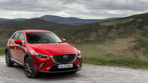 Caption: Sleek Red Mazda Cx-3 In Motion Wallpaper