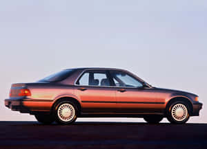 Caption: Sleek Silver Acura Legend Cruising The Streets Wallpaper