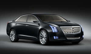 Caption: Sleek Silver Cadillac Xts In Urban Landscape Wallpaper