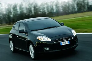 Caption: Sleek Silver Fiat Bravo Car Glowing Under The Evening Sky Wallpaper