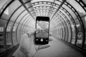 Caption: Sleek Silver Iphone Displayed Against A Tranquil Floral Background Wallpaper