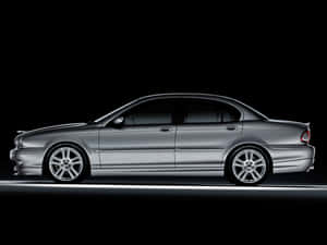 Caption: Sleek Silver Jaguar X-type On Display Wallpaper