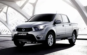 Caption: Sleek Ssangyong Suv On A Scenic Drive Wallpaper