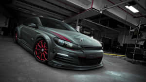 Caption: Sleek Volkswagen Scirocco Gliding On The Highway Wallpaper