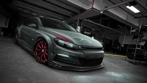 Caption: Sleek Volkswagen Scirocco Gliding On The Highway Wallpaper