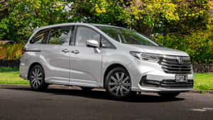 Caption: Sleek White Honda Odyssey On The Road Wallpaper