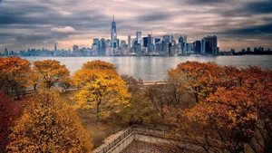 Caption: Spectacular Fall View Of The Freedom Tower On Liberty Island Wallpaper