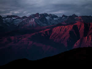 Caption: Spectacular Night Sky Over Dark Mountain Wallpaper