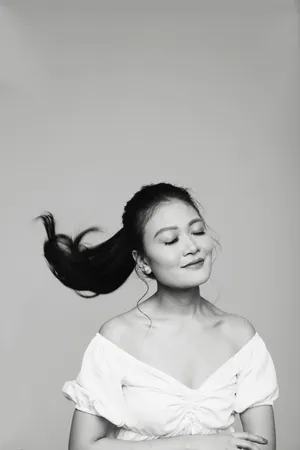 Caption: Striking Monochrome Portrait Of A Woman Flipping Her Ponytail Hair Wallpaper