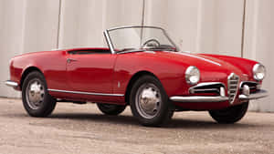 Caption: Stunning Alfa Romeo Spider In Vibrant Red Wallpaper