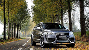 Caption: Stunning Audi Q7 In A Picturesque Landscape Wallpaper