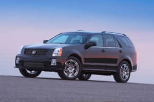 Caption: Stunning Cadillac Srx On The Open Road Wallpaper