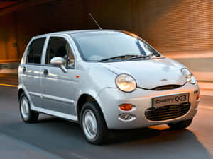 Caption: Stunning Chery Automobile In Action Wallpaper