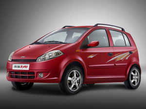 Caption: Stunning Chery Car In Vibrant Cityscape Wallpaper