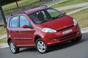 Caption: Stunning Chery Model On The Open Road Wallpaper