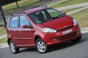 Caption: Stunning Chery Model On The Open Road Wallpaper