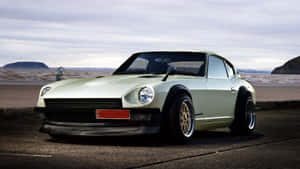 Caption: Stunning Datsun Classic Car On Road Wallpaper