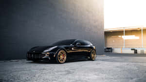 Caption: Stunning Ferrari Ff In Scenic Mountains Wallpaper