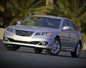 Caption: Stunning Hyundai Azera In Motion On A Scenic Road Wallpaper