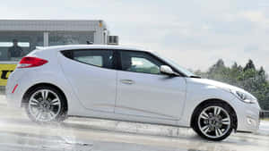 Caption: Stunning Hyundai Veloster In Scenic Landscape Wallpaper