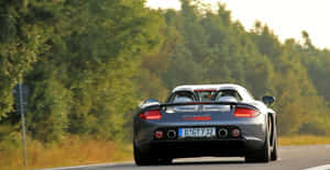 Caption: Stunning Porsche Carrera Gt Ready To Race Wallpaper