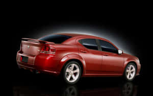 Caption: Stunning Silver Dodge Avenger Cruising On The Road Wallpaper