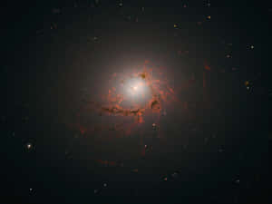 Caption: Stunning View Of A Dazzling Elliptical Galaxy Wallpaper