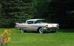 Caption: Stunning White Cadillac Deville On Scenic Road Wallpaper